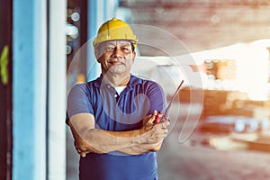 Southeast asian male worker foreman standing portrait smile with radio control loading cargo shipping industry