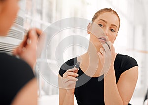 A southern drawl, a world unseen. a young ballet dancer applying lipstick before performing at a dance rehearsal.