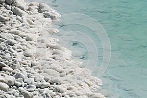 The southern part of the Dead Sea, is divided into pools from which extract minerals. The rocky shore is covered with white salt