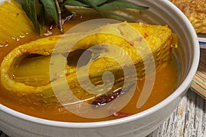 Southern Thai Gaeng Som - Red Tilapia fish soup with papaya.