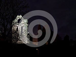 The southern Transept tower of Arbroath Abbey with its distinctive Round Window lit up by Floodlights