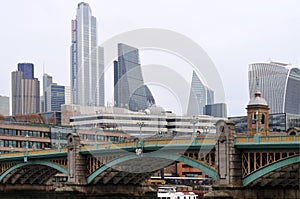 Southwark bridge in London with modern skyline in background