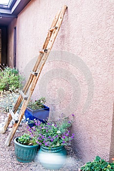 Southwest Adobe Home with ladder on the side in New Mexico