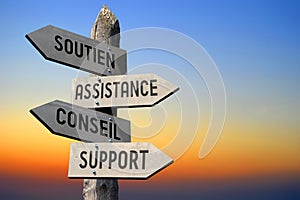 Soutien, Assistance, Conseil, Support - French/ help, assistance, advice, support - English - wooden signpost, sunset sky