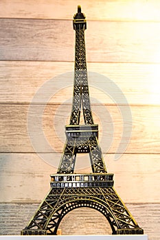 Souvenir Eiffel Tower on wood pattern background.