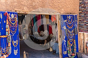 Souvenir shop with carpets, traditional clothes and other things in clay town of Ait Ben Haddou, Morocco.