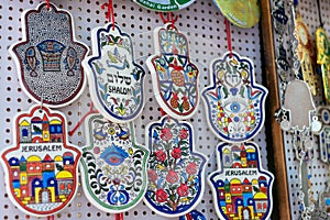 Souvenirs at Jerusalem bazaar, hamsa or khamsa symbol of Judaism, inscription in Hebrew