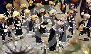 Souvenirs in the window. Glass Symphony Orchestra. Figurines of musicians playing, performing music on musical instruments