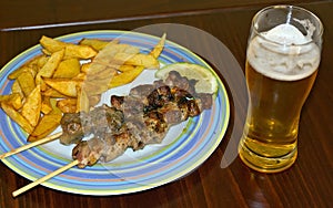 Souvlaki, fried potatoes and beer