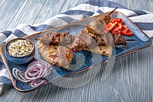Souvlaki grilled beef and pork on skewers. Natural delicious food. Greek cuisine menu. Still life in a marine style