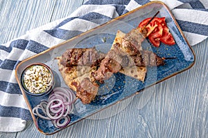 Souvlaki grilled beef and pork on skewers. Natural delicious food. Greek cuisine menu. Still life in a marine style