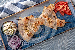 Souvlaki grilled chicken fillet on skewers. Natural delicious food. Greek cuisine menu. Still life in a marine style