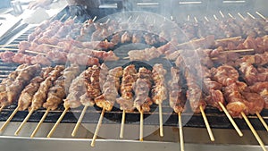 Souvlaki or suvlaki on grilling on the fire many with smoke traditiona greek stree food