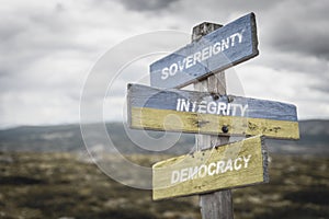 sovereignty integrity democracy text quote on wooden signpost outdoors, written on the ukranian flags