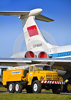 Soviet airfield machine to check aircraft hydraulic system near the passenger plane