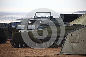 Soviet amphibious transporter and UAZ military off-road vehicle mounted on it in Park of the 300th anniversary of St. Petersburg