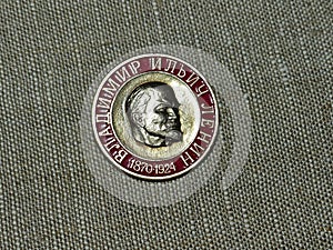 Soviet badge depicting Vladimir Ilyich Lenin with the inscription in Russian `Lenin` from the collections