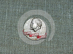 Soviet badge depicting Vladimir Ilyich Lenin Ulyanov with the inscription in Russian, English and French `Lenin`