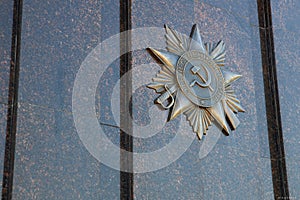 Soviet bronze Order of the Great Patriotic War on the marble monument in the city of Sambek