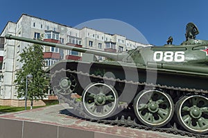 Soviet caterpillar tank T 54 in a green color. Monument. Side view.