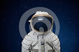 Soviet cosmonaut or astronaut or spaceman suit and helmet on black space with stars background