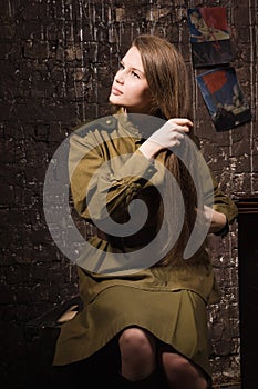 Soviet female soldier of World War II combs her hair