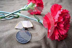 Soviet Medal for Combat Service and two red carnations