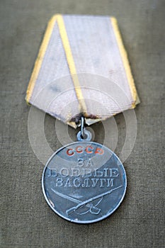 Soviet Medal for Combat Service and two red carnations.