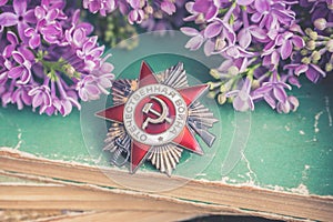 The Soviet order of the Second World war on natural moss background witj lilac branch, Victory Day 9 May