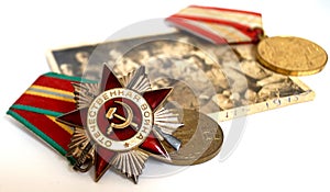Soviet orders and medals lie on an old military photograph