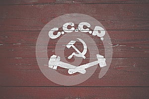 Soviet painted coat of arms. Hammer and sickle drawn on wooden boards
