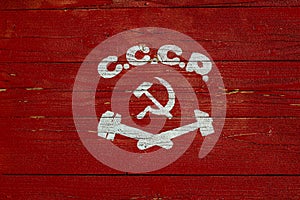 Soviet painted coat of arms. Hammer and sickle drawn on wooden boards