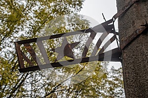 Soviet star rusted sign on the building the ghost town Chernobyl