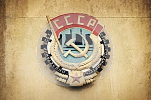 Soviet union CCCP emblem with hammer and sickle on a wall photo