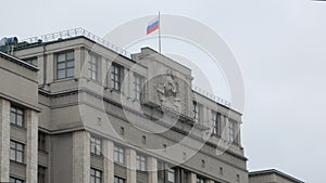 Soviet Union emblem on government buildings in Russia, close-up, contemporary flag on top