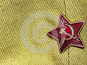 Soviet Union Hammer and Sickle Badge on Woven Fabric Background