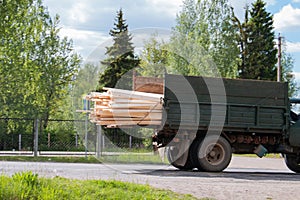 Soviet ZIL truck tramsports wooden building materials, still on move, lumber, body, engine on gas