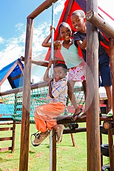 African kids playing on Jungle Gym and other park equipment at local public playground