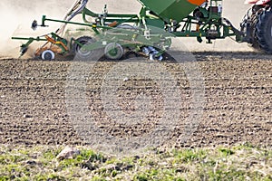 Sowing time.tractor trailer rides on the field and sows grain