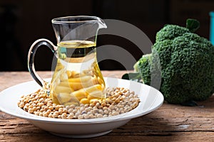 Soy bean and soy oil on table