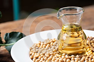 Soy bean and soy oil on table