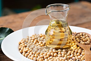 Soy bean and soy oil on table