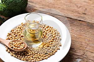 Soy bean and soy oil on table