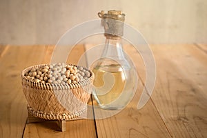 Soy bean and soy oil on a wooden table