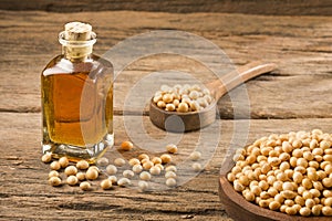 Soy bean and soy oil on wooden table - Glycine max. Text space