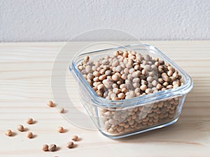 Soy beans in square glass  bowl on wooden table