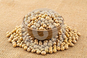 Soy beans in a wooden bowl on sack cloth