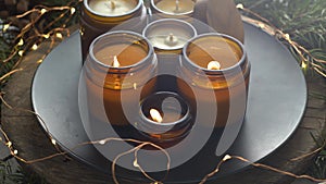 Soy candles burn in glass jars. Comfort at home. Candle in a brown jar. Scent and light. Scented handmade candle. Aroma