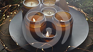 Soy candles burn in glass jars. Comfort at home. Candle in a brown jar. Scent and light. Scented handmade candle. Aroma