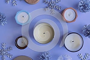 Soy candles and christmas decoration on blue background